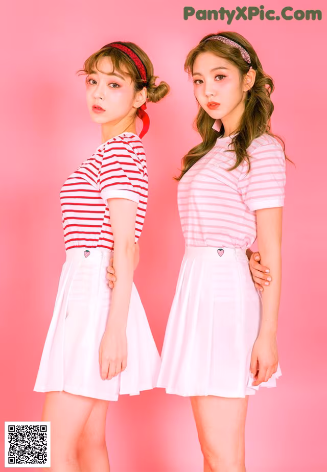 A couple of young women standing next to each other.