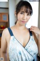 A woman in a blue and white dress posing for the camera.