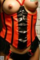 A woman wearing a red and black corset.