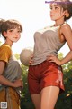 A couple of women standing next to each other holding a soccer ball.