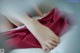 A close up of a woman's feet on a bed.