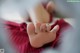 A close up of a baby's foot on a bed.